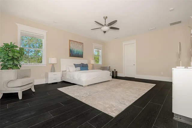 a bathroom with a bathtub sink double vanity and mirror