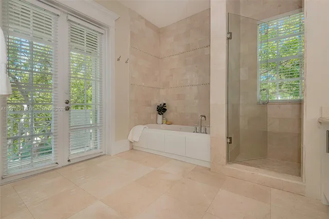 a bathroom with a double vanity sink a mirror and a shower