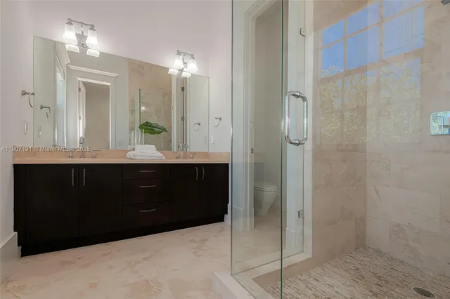 a view of a livingroom with wooden floor and a ceiling fan