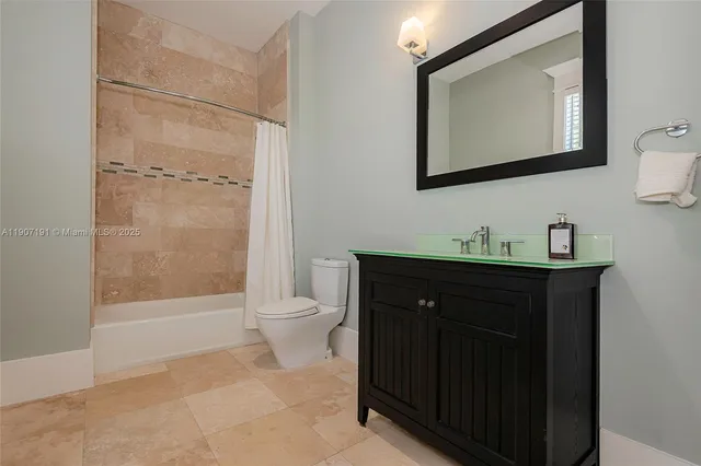 a spacious bathroom with a tub and a toilet