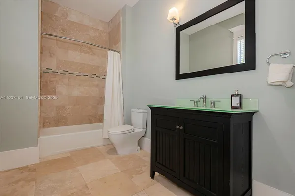 a spacious bathroom with a tub and a toilet