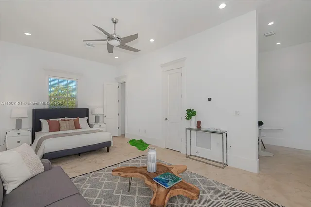a front view of a house with a yard and potted plants