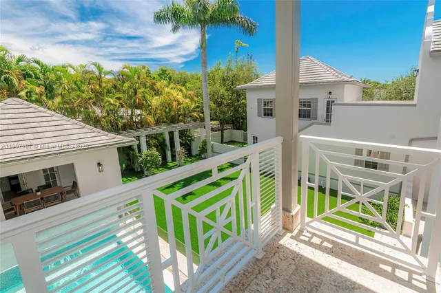 a view of a house with backyard and a patio