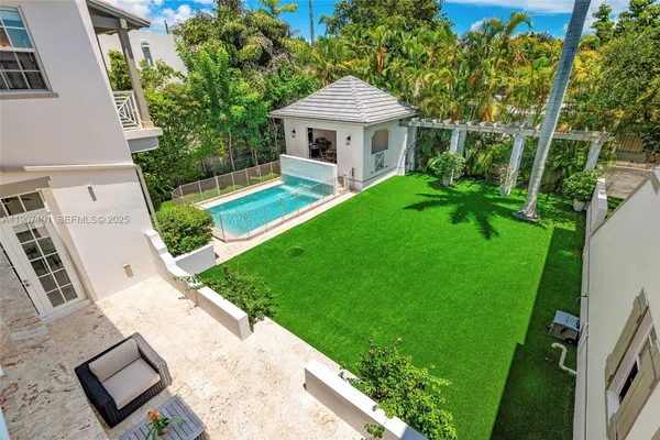 a view of a house with a yard and sitting area