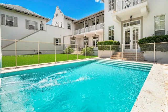 an aerial view of multiple houses with yard