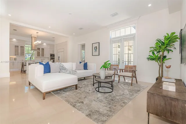 a kitchen with stainless steel appliances kitchen island a table and chairs in it