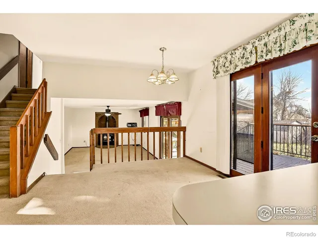 a bedroom with furniture and large window