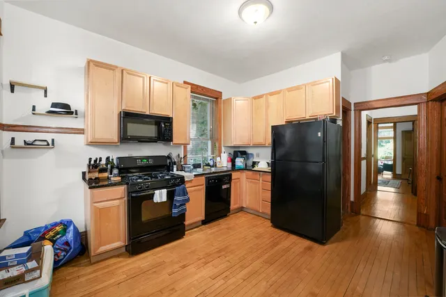 a kitchen with stainless steel appliances granite countertop a refrigerator stove top oven a sink and dishwasher