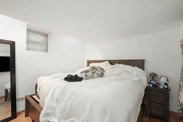 a bedroom with a bed and window