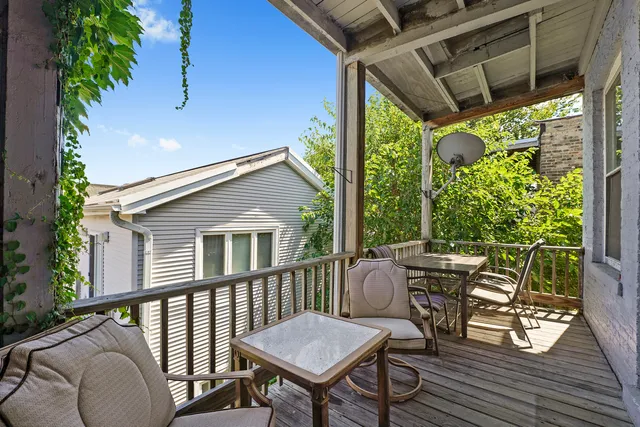 a view of a patio with table and chairs and wooden floor