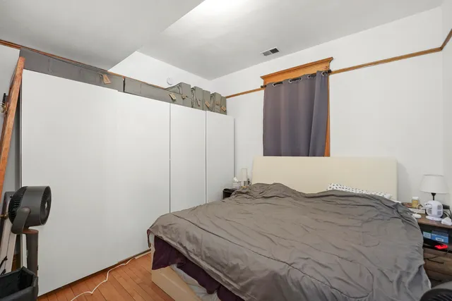 a bedroom with a bed and a mirror