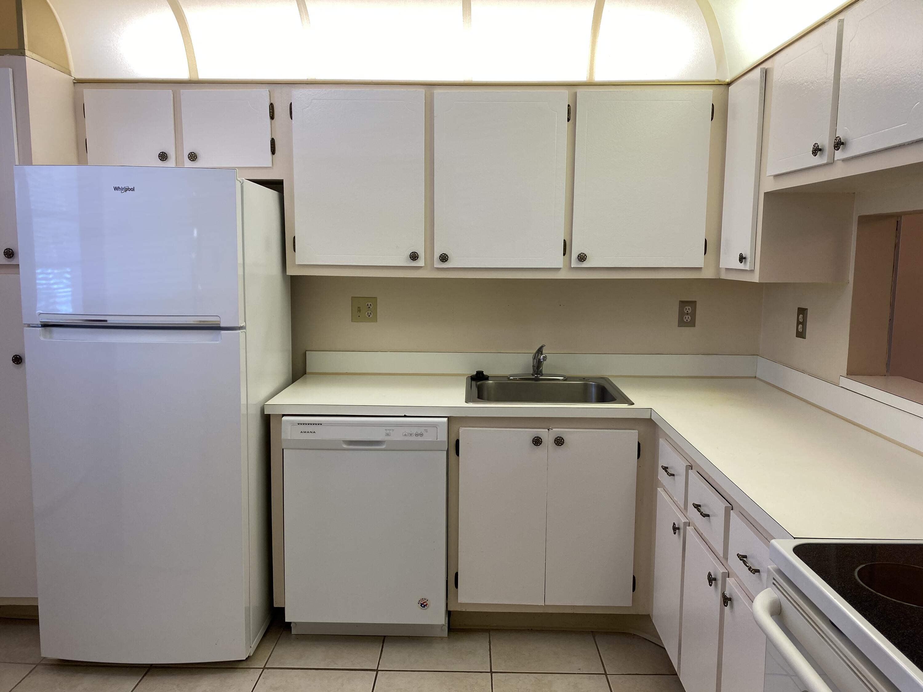 2500 Fiore Way, Unit 1110 Delray Beach, FL 33445 - Photo 3 of 12 a utility room with dryer and washer