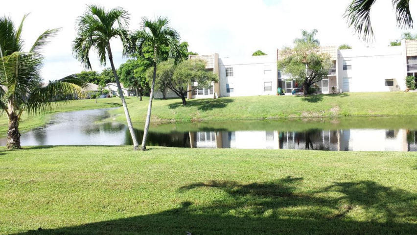 2500 Fiore Way, Unit 1110 Delray Beach, FL 33445 - Photo 9 of 12 a view of swimming pool with a garden and plants