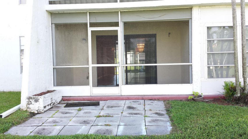2500 Fiore Way, Unit 1110 Delray Beach, FL 33445 - Photo 10 of 12 a white bench sitting in front of a house
