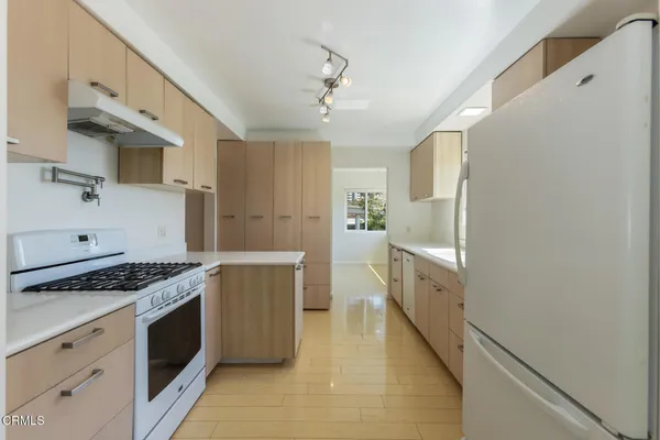 a kitchen with cabinets and a stove top oven
