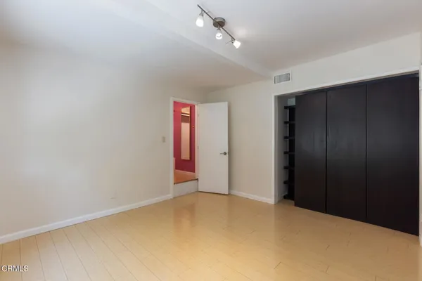 an empty room with closet area