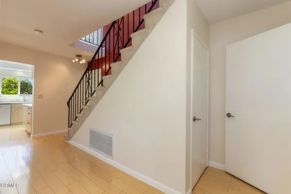 a view of entryway and hall with wooden floor