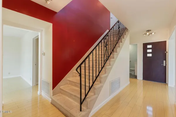 a view of staircase with wooden floor and stairs