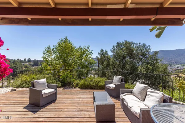 a view of a patio with couches and potted plants
