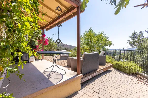 a view of a chairs and table in the patio