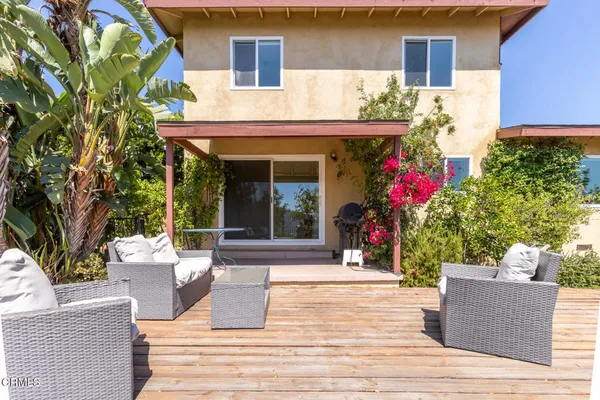 a view of a house with potted plants