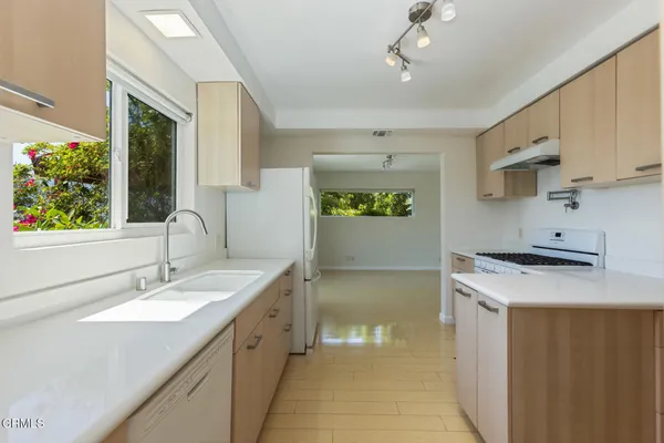 a kitchen with a sink stove and cabinets