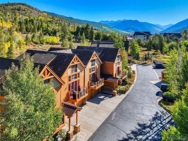 an aerial view of a house with swimming pool and garden