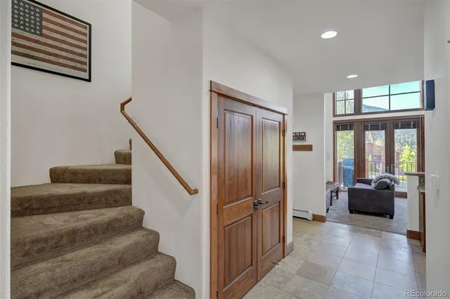 a view of staircase with black carpet
