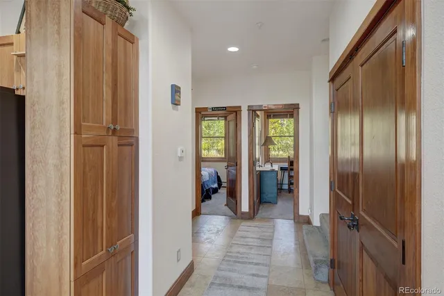 a view of a hallway with wooden shelves