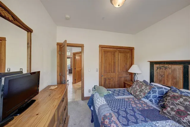 a bedroom with furniture and a flat screen tv