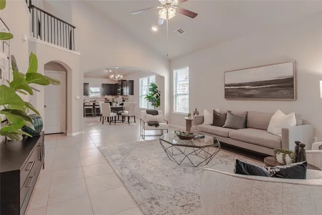 a view of a dining room with furniture and a chandelier
