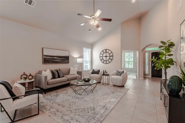 a living room with furniture and a chandelier