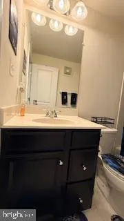 a bedroom with two beds and a lamp