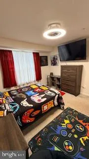 a bedroom with a bed and a dresser next to a window