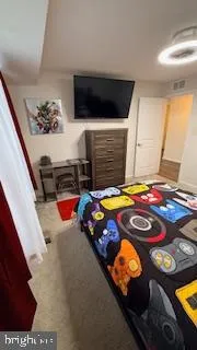 a bedroom with a bed and a night stand