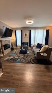 a living room with furniture window and a flat screen tv