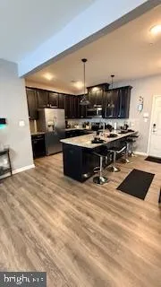a kitchen with stainless steel appliances kitchen island granite countertop a stove and a sink