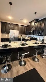 a kitchen with a sink a stove and chairs