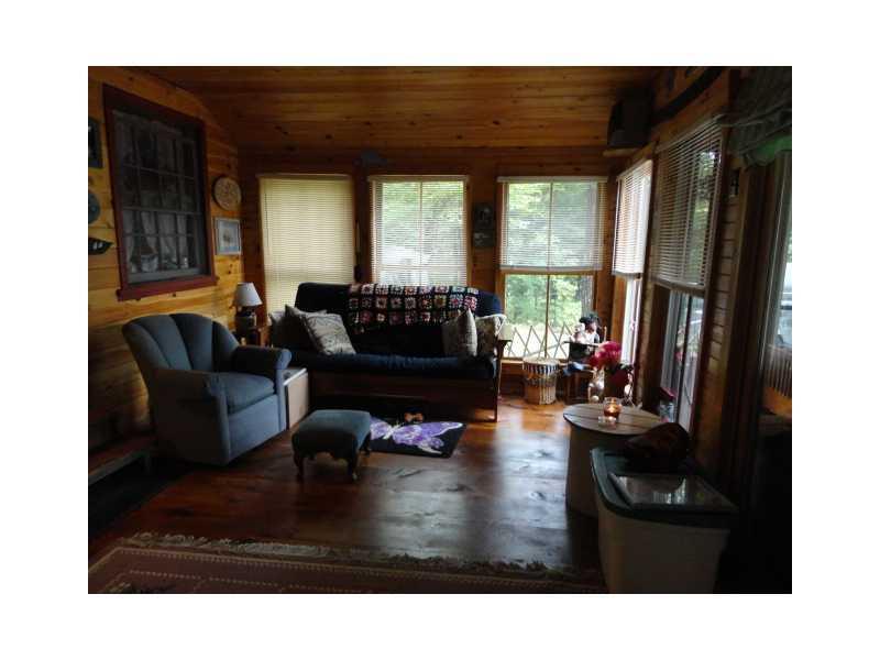 120 Seymour Cove Road Dover-Foxcroft, ME 04426 - Photo 8 of 19 Other. Sunroom with wood floor and...