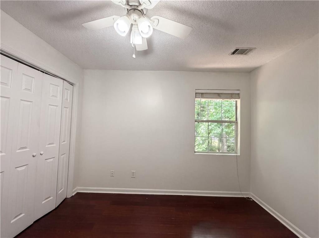 3753 Soapstone Road Decatur, GA 30034 - Photo 17 of 26 an empty room with wooden floor and windows