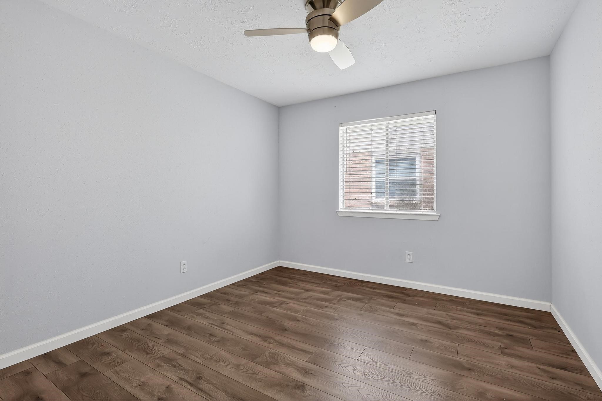 7331 Misty Morning Drive Humble, TX 77346 - Photo 16 of 19 wooden floor in an empty room with a window