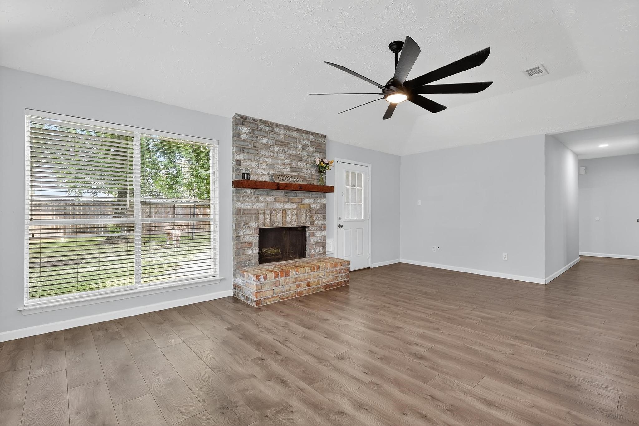 7331 Misty Morning Drive Humble, TX 77346 - Photo 3 of 19 a view of empty room with wooden floor and fan