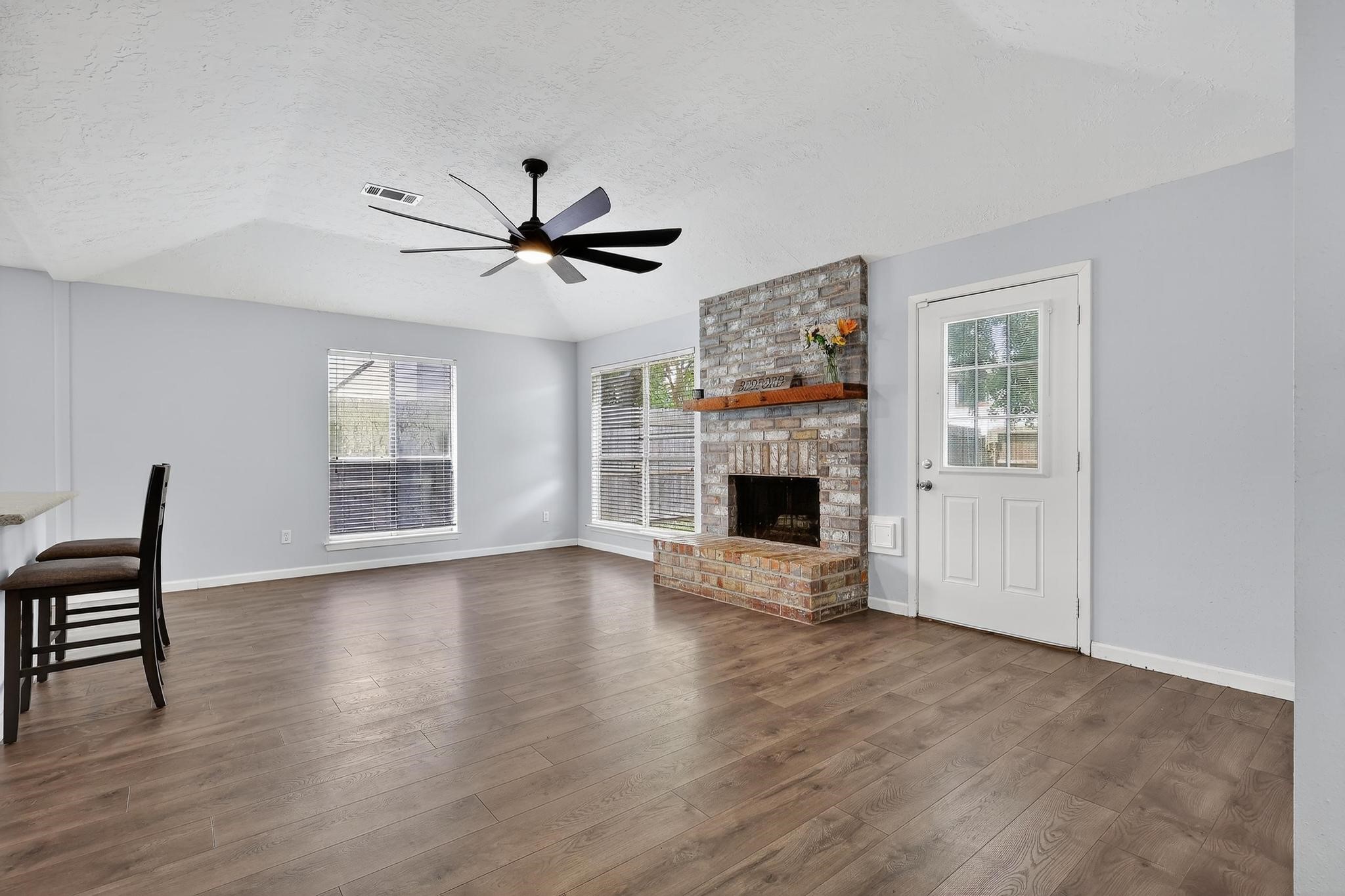7331 Misty Morning Drive Humble, TX 77346 - Photo 4 of 19 a view of empty room with fireplace and wooden floor