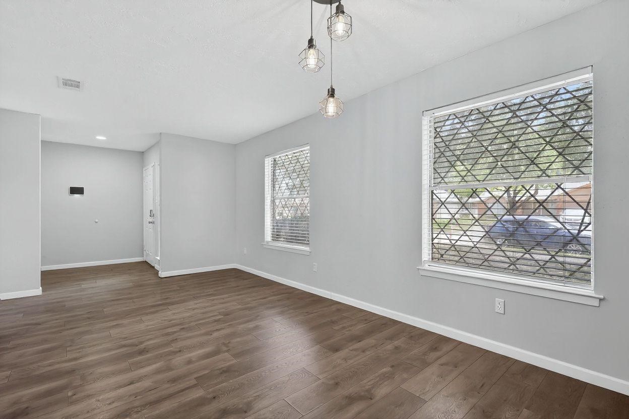 7331 Misty Morning Drive Humble, TX 77346 - Photo 10 of 19 an empty room with wooden floor and windows