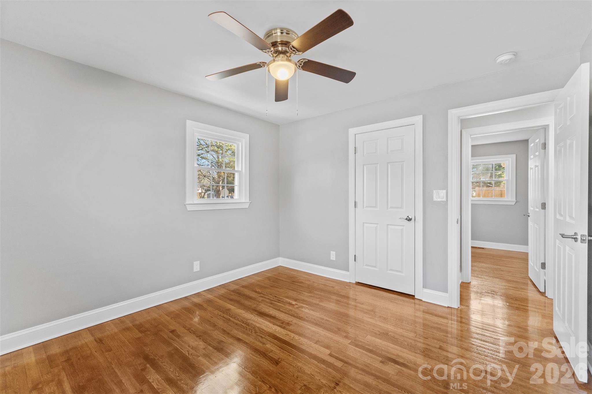 206 Hunter Street York, SC 29745 - Photo 10 of 20 an empty room with wooden floor and ceiling fan