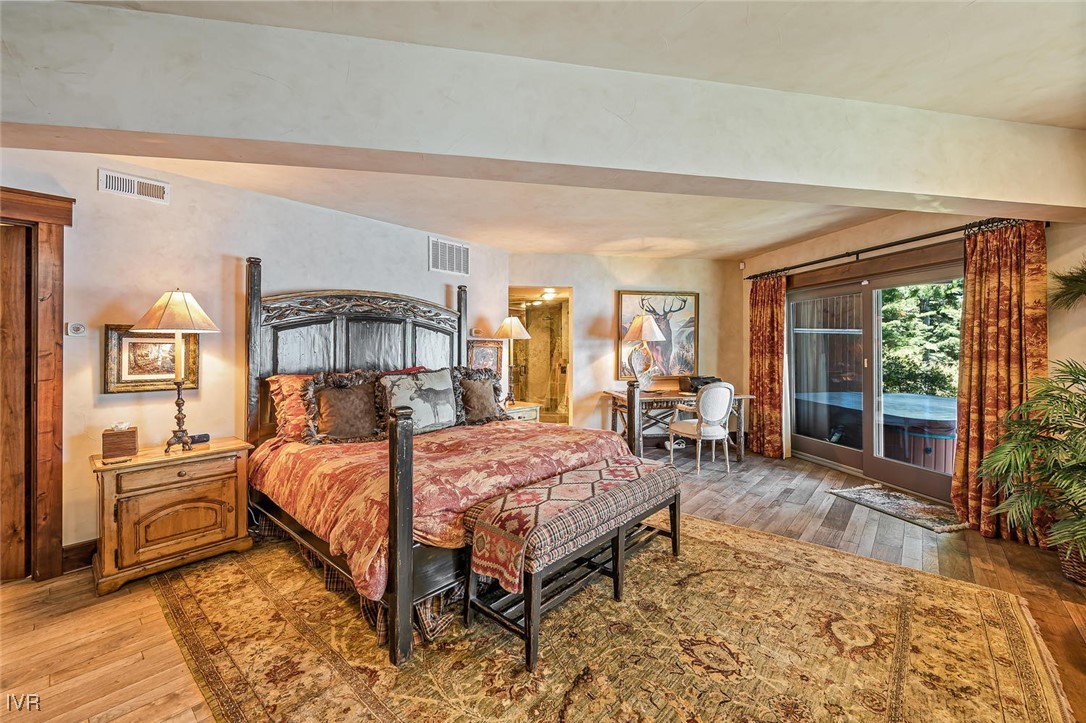 422 Gonowabie Road Crystal Bay, NV 89402 - Photo 21 of 49 a bedroom with a bed and wooden floor