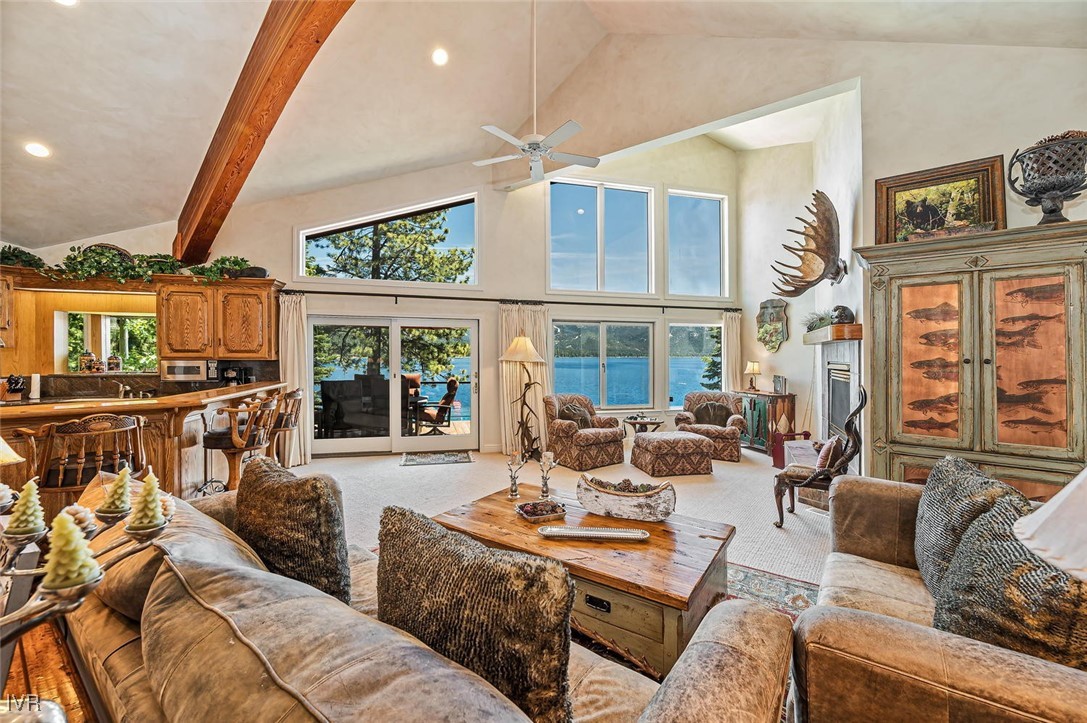 422 Gonowabie Road Crystal Bay, NV 89402 - Photo 8 of 49 a living room with furniture a flat screen tv and a floor to ceiling window