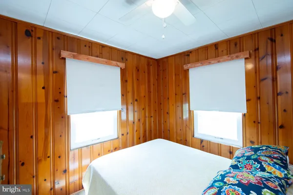 a bedroom with a bed and a view of living room