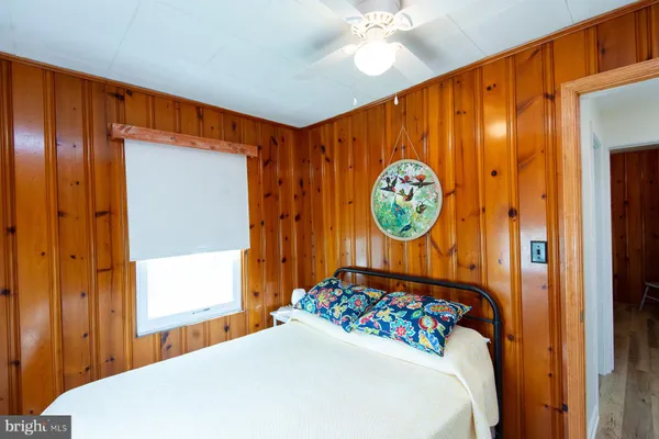 a bedroom with a bed and a view of bedroom