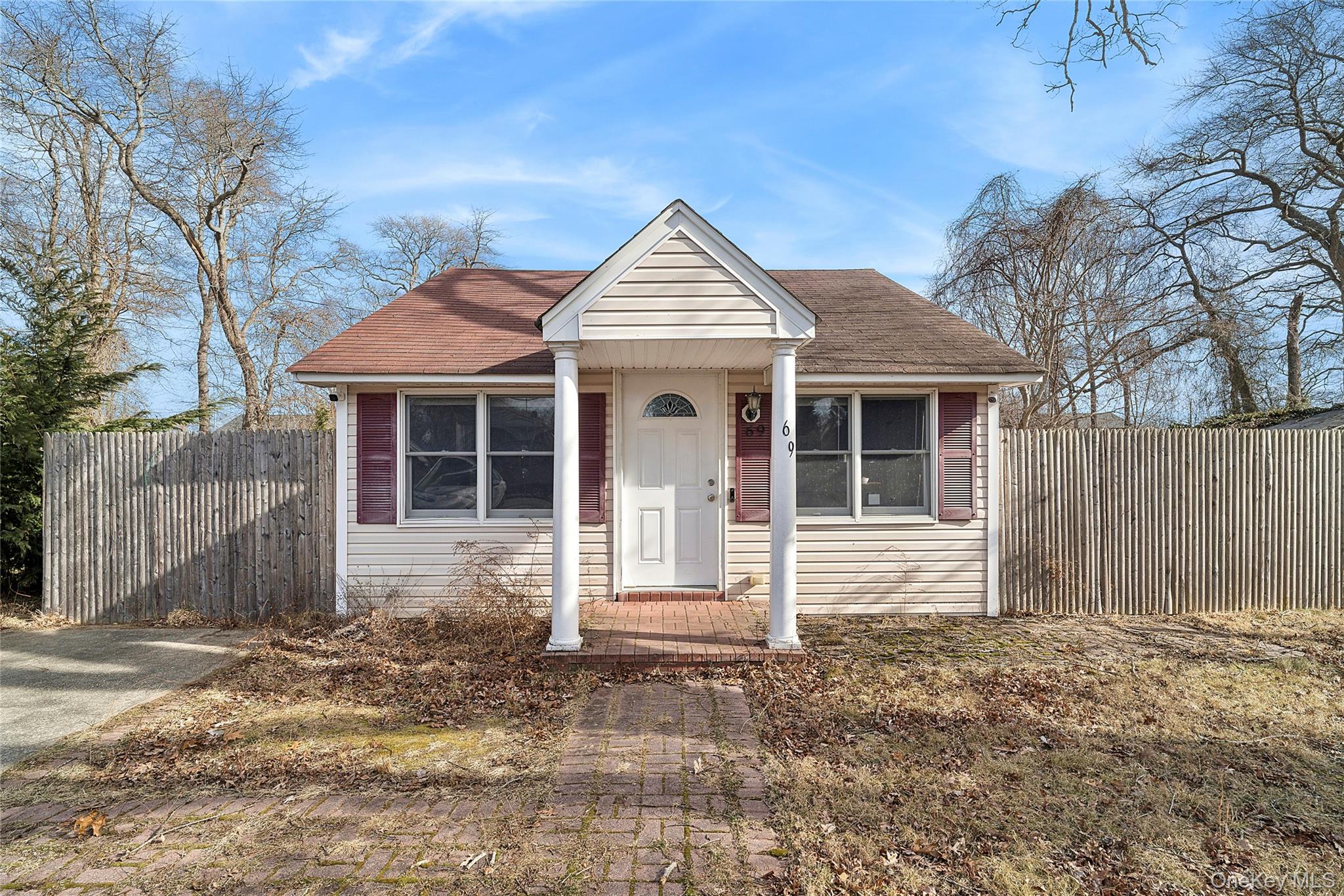 69 Locust Drive Mastic Beach, NY 11951 - Photo 13 of 13 a front view of a house with a yard and garage